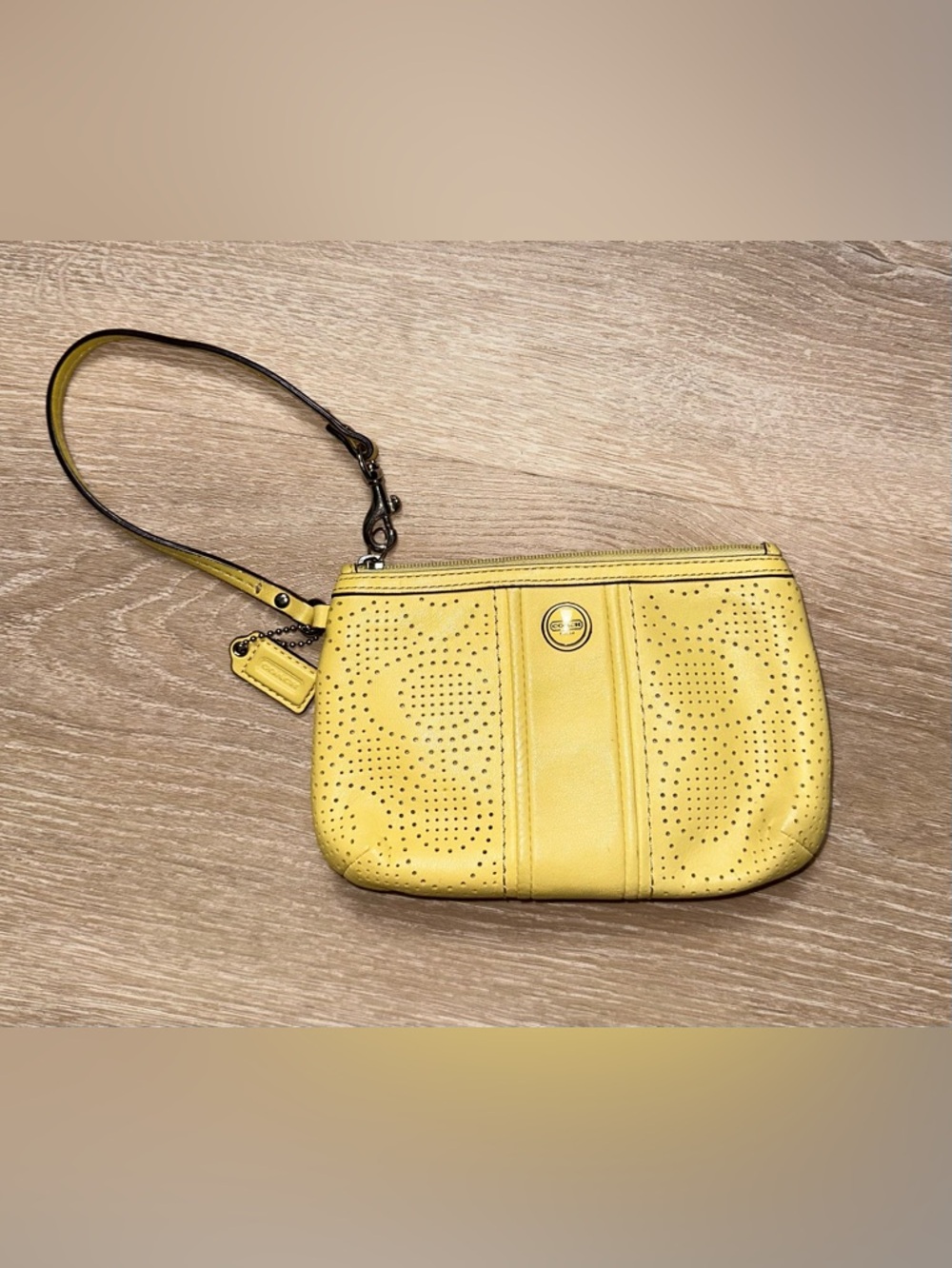Coach Perforated Leather Wristlet in a vibrant yellow with hang tag